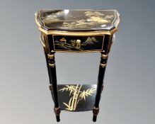 A Chinese black lacquered hall table fitted a drawer