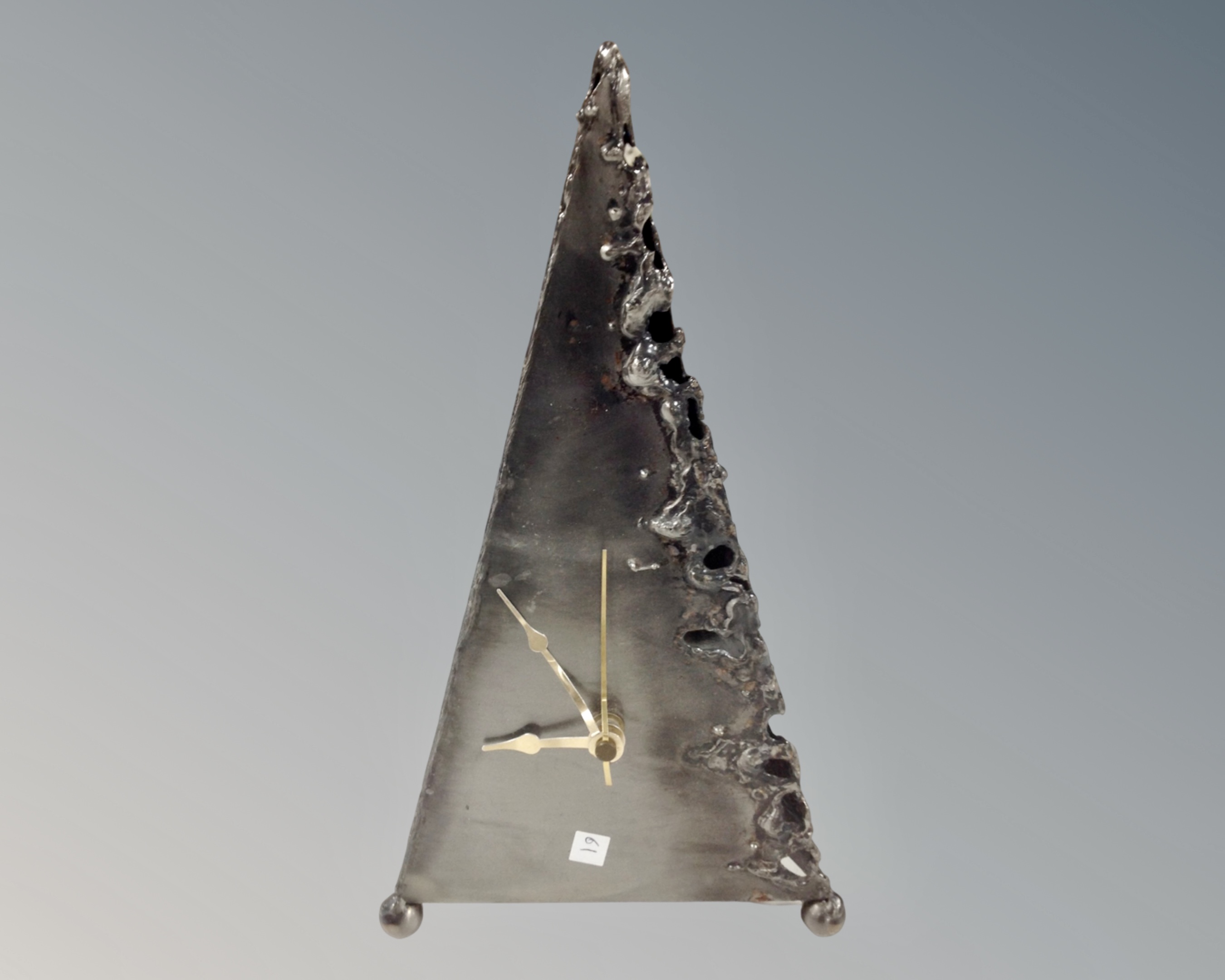 A contemporary steel mantel clock