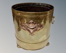 A brass Art Nouveau coal bucket with liner