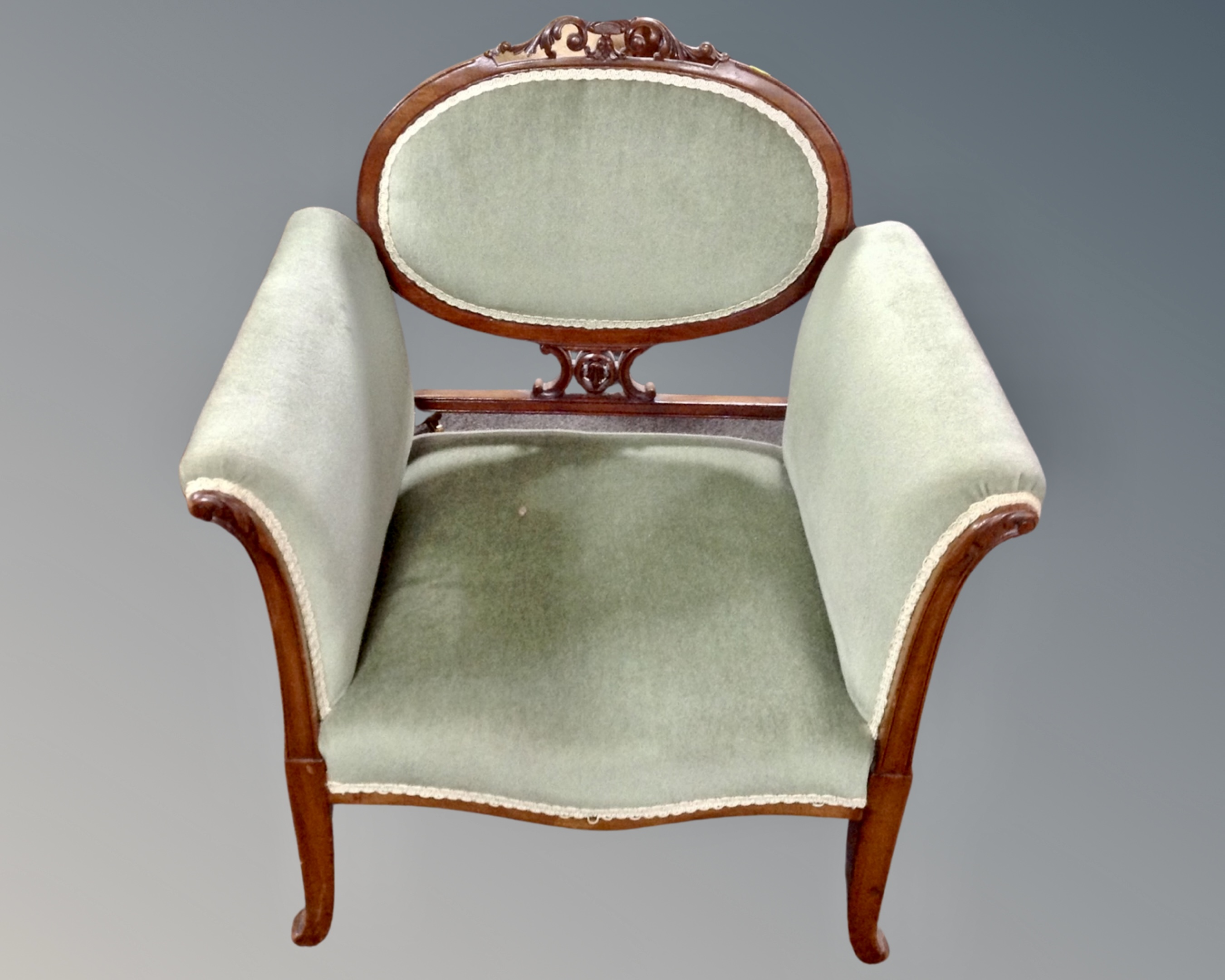 A 19th century carved beech framed armchair in green dralon