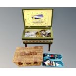 A 20th century sewing box on legs containing sewing items,