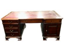 A Victorian style mahogany twin pedestal partners desk with red leather inset panel