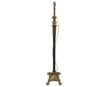 An antique heavy cast brass standard lamp