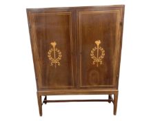 A continental inlaid mahogany cabinet on raised legs