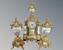 An ornate French style gilt metal and china clock garniture with battery movement
