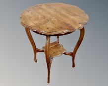 An Edwardian mahogany two tier shaped occasional table