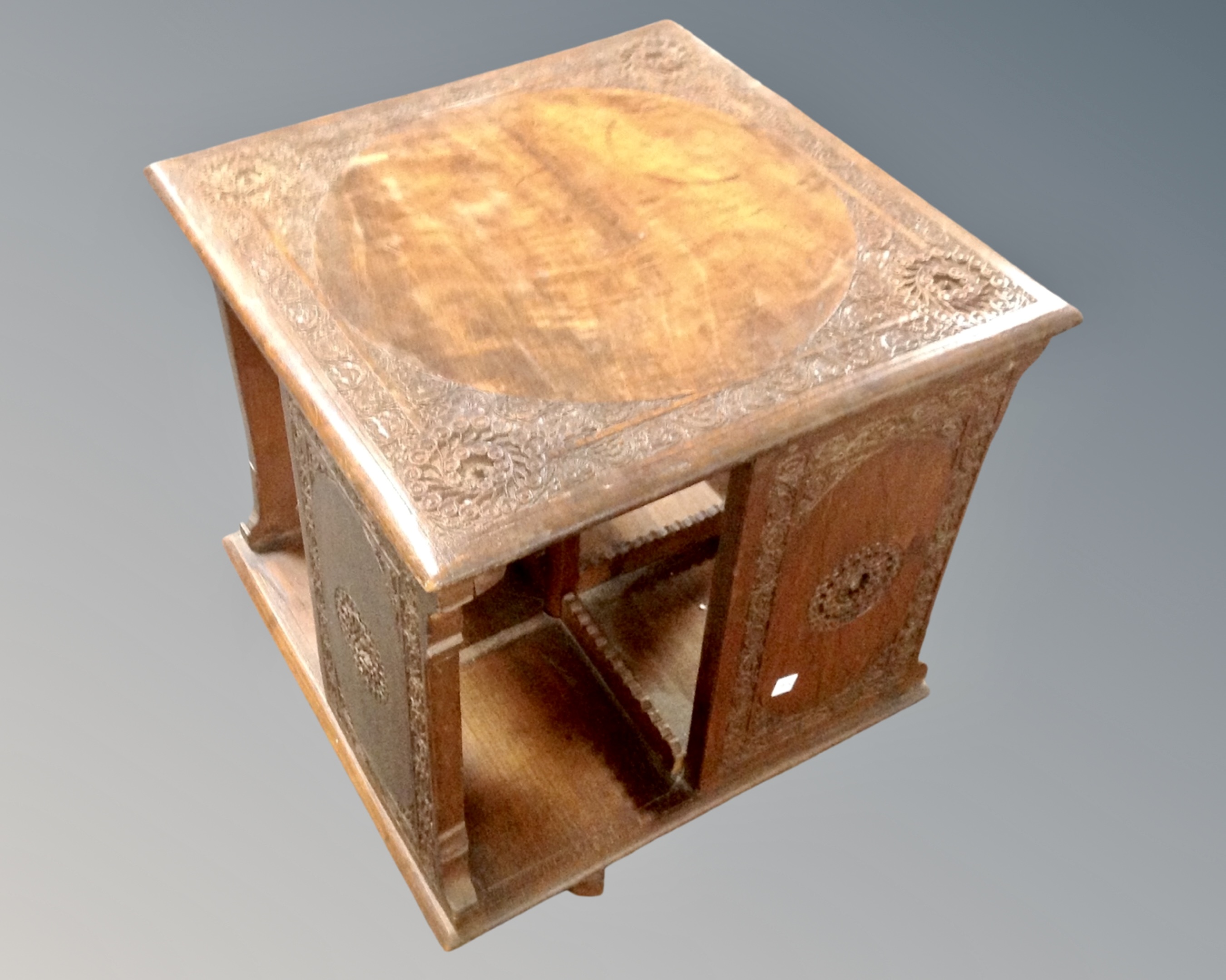 A carved Indian revolving table top book stand