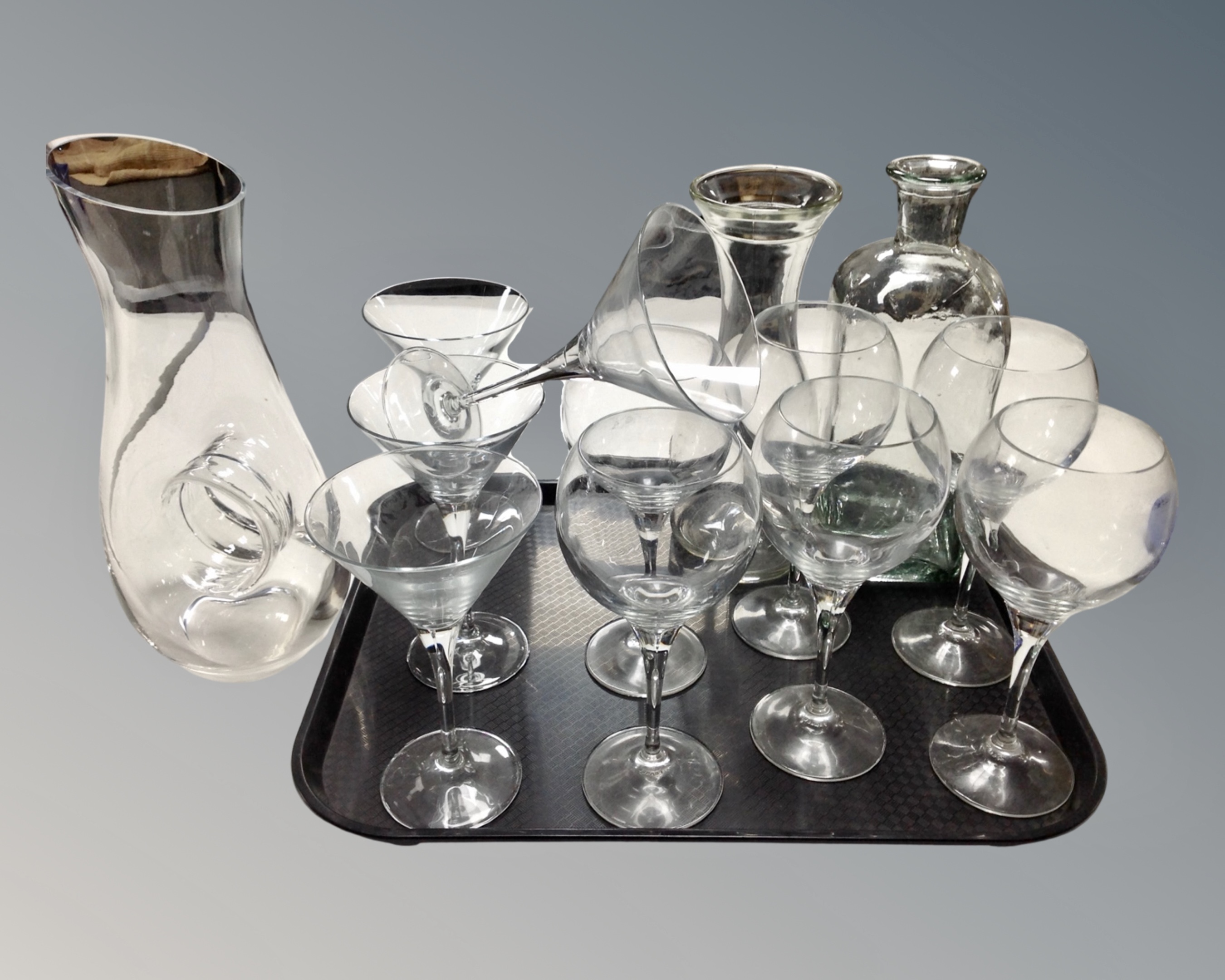 Two trays of assorted glass ware : drinking glasses, wine carafes,