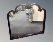 A contemporary black framed over mantel mirror