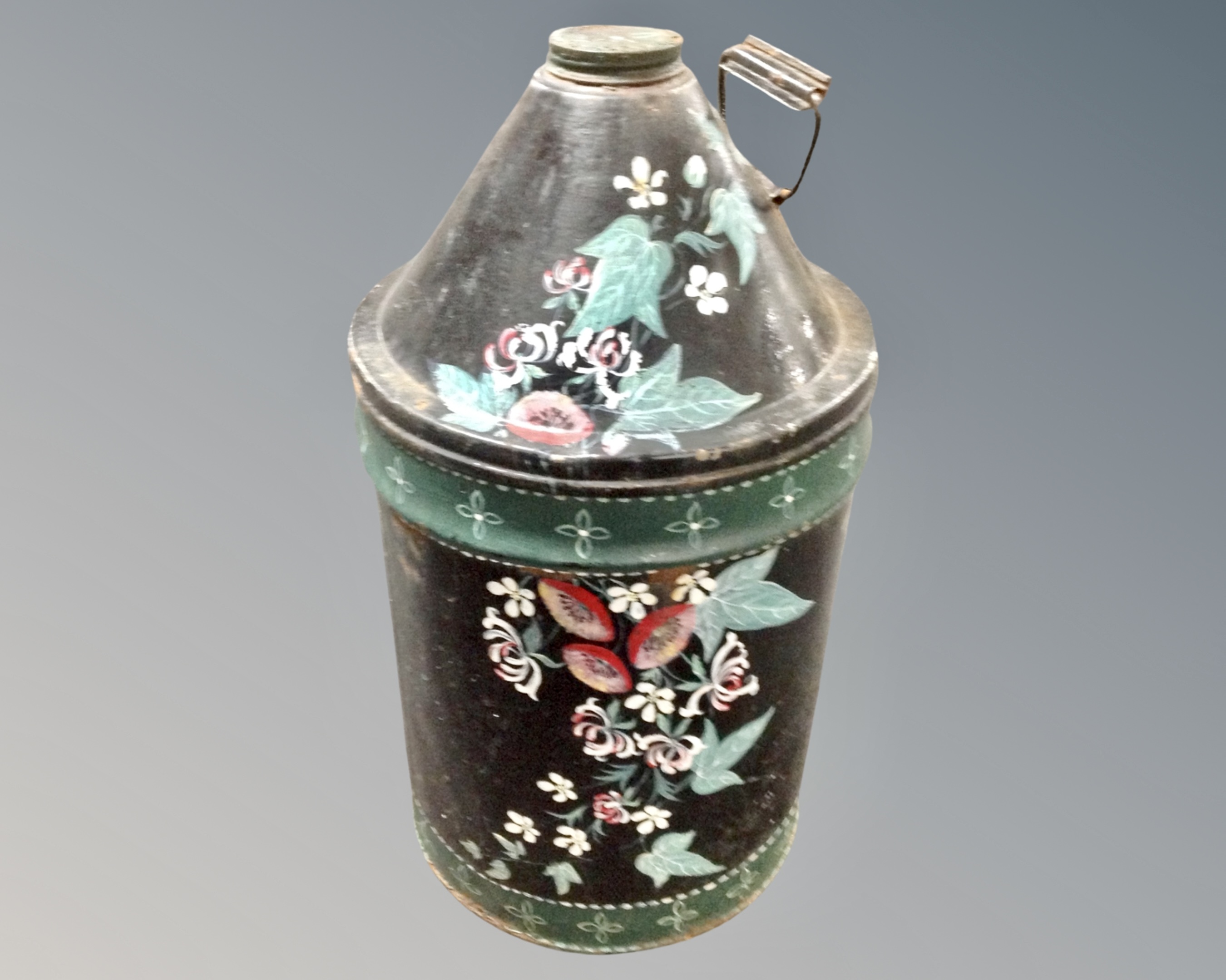 An antique hand painted metal canister