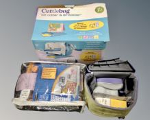A Cuttlebug Die Cutter and Embosser, boxed and a Xyron runner in carry bag,