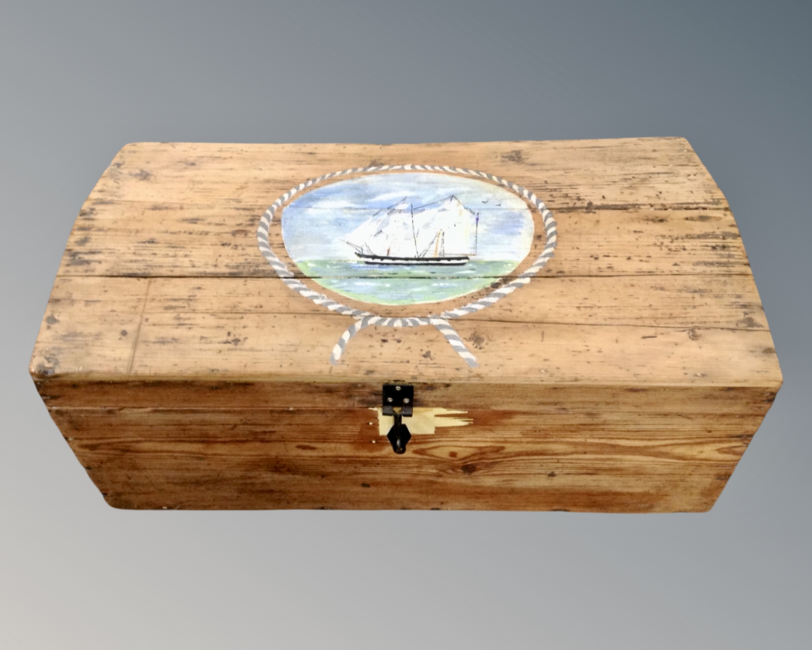 A pine domed topped box with hand painted nautical scene panel