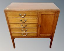 An Edwardian mahogany five drawer music cabinet fitted a cupboard on raised legs