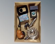 A box of silver plated wine tasting cup, vintage pipe, cloisonne match holder,