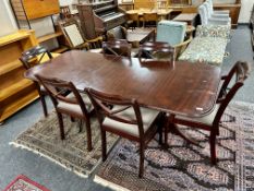 A mahogany twin pedestal table with leaf and six chairs