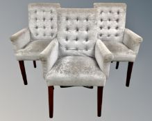 A set of three contemporary high backed armchairs upholstered in silvered fabric