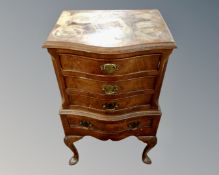 A mahogany and walnut serpentine fronted four drawer chest