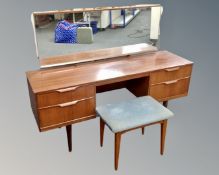 An Austinsuite teak twin pedestal dressing table with mirror on raised legs (width 147cm),