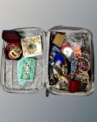 A suitcase containing a quantity of costume jewellery and trinkets.