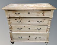 An antique pine four drawer chest on bun feet.