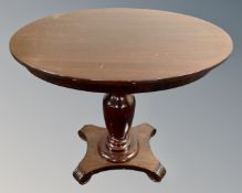 A mahogany and beech oval pedestal occasional table.