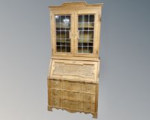 A 20th century Scandinavian blonde oak secretaire bureau fitted with three drawers beneath and
