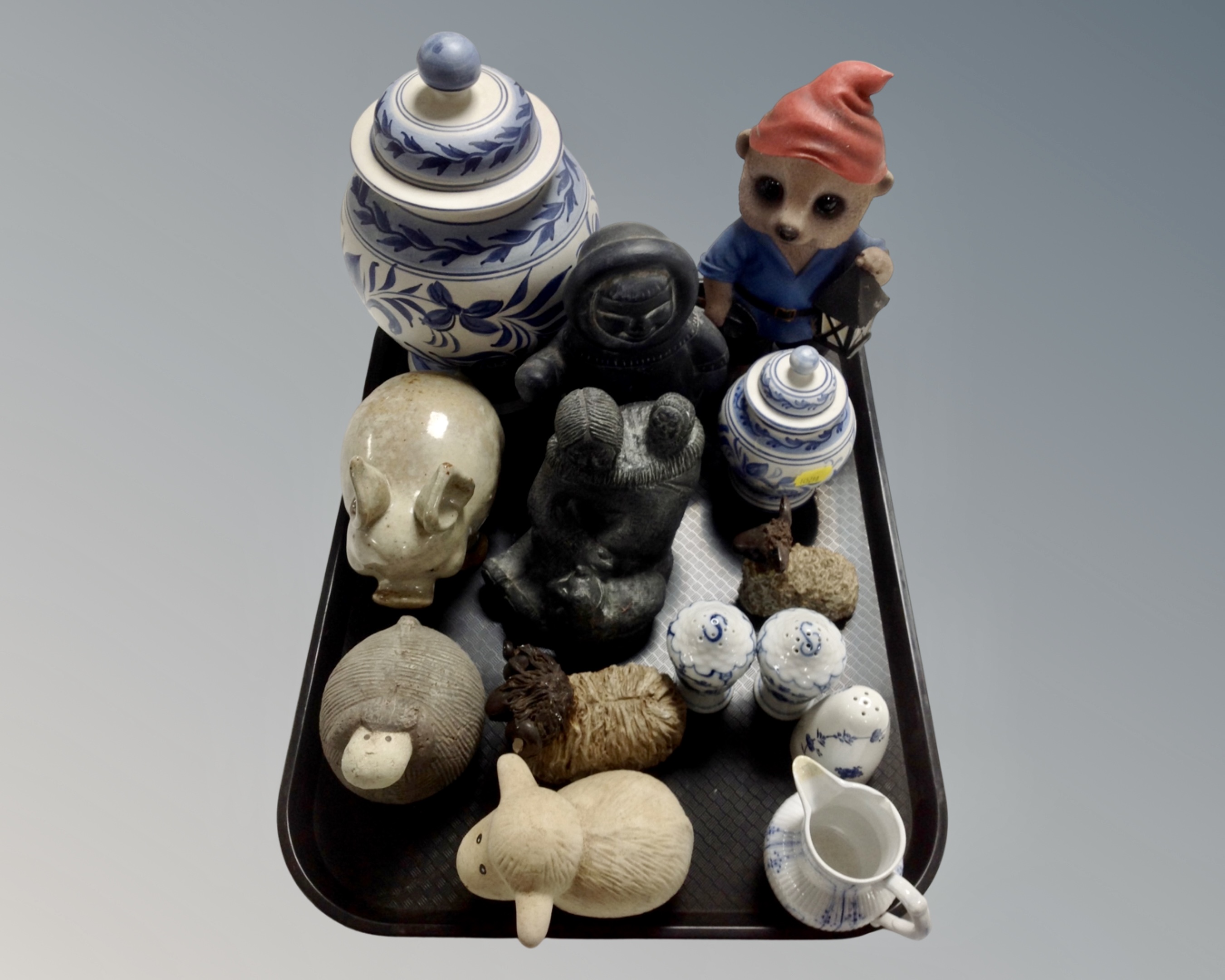 A tray containing pottery animal figures, Inuit carvings, earthenware vase,