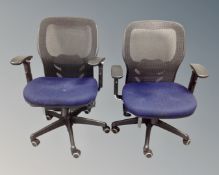 Two contemporary office adjustable swivel armchairs with fabric seats and mesh backs.
