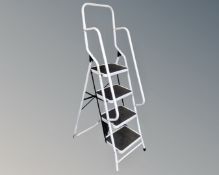 A four-tread folding step ladder with double hand rail
