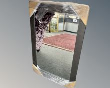 A contemporary mirror in a grey frame, 66cm by 96cm.