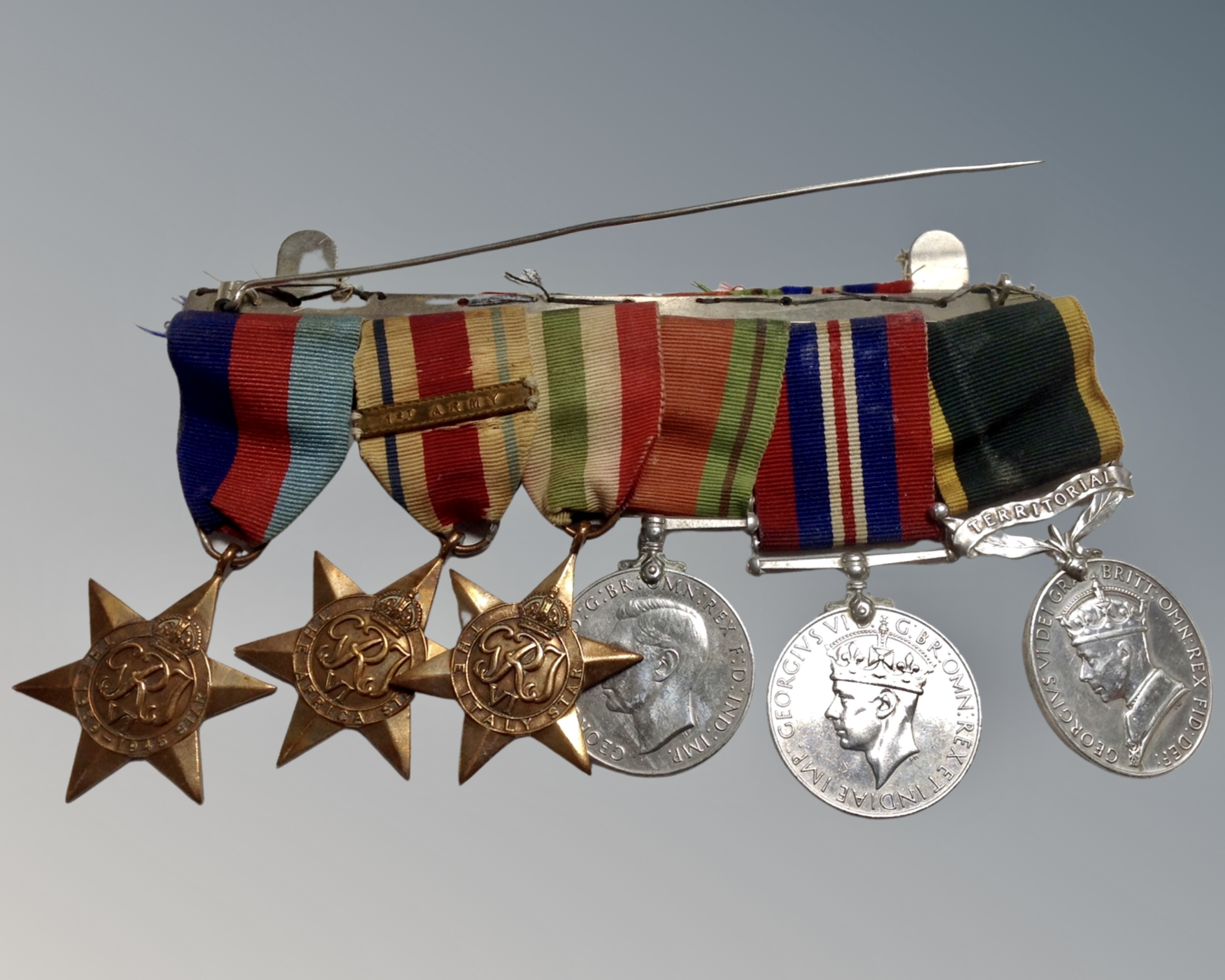 A Second World War medal bar comprising 1939-45 Star, Africa Star, Italy Star, Defence Medal,