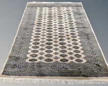 A Lahore Bokhara rug, Pakistan, on cream ground, 246cm by 153cm.