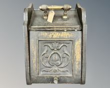 An Edwardian coal receiver, with carved hinged lid, brass carry handle,