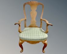 A 20th century oak Queen Anne style armchair.