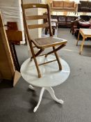 A white circular pedestal table with plate glass top (diameter 76cm),
