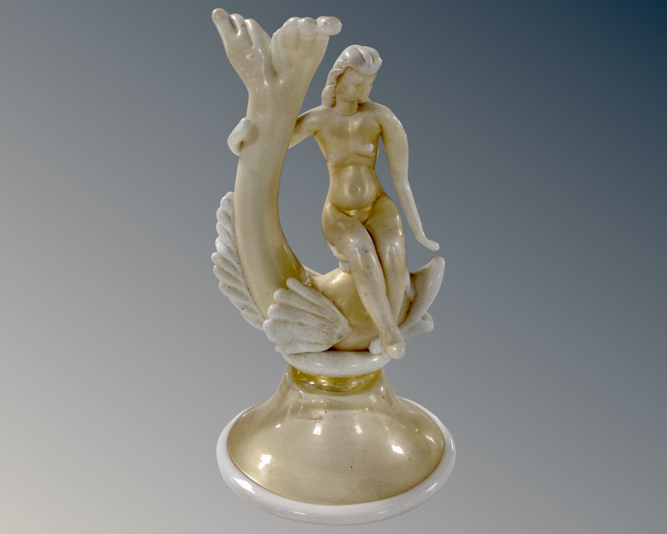 A Venetian glass sculpture of a nude woman sitting on a dolphin, probably by Barovier & Toso.