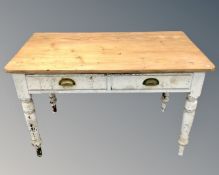 A Victorian pine kitchen table on painted base fitted with two drawers.