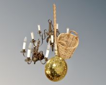 Two continental brass five way light fittings together with a wicker twin handled basket and bed