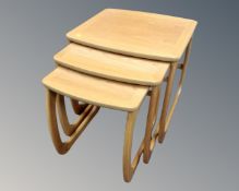 A nest of three Nathan Furniture occasional tables in a light oak.