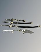 A set of three graduated Japanese style katanas together with two further fantasy knives,