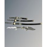 A set of three graduated Japanese style katanas together with two further fantasy knives,