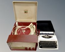 A mid-20th century HMV portable electric record player together with an Adler typewriter in case.