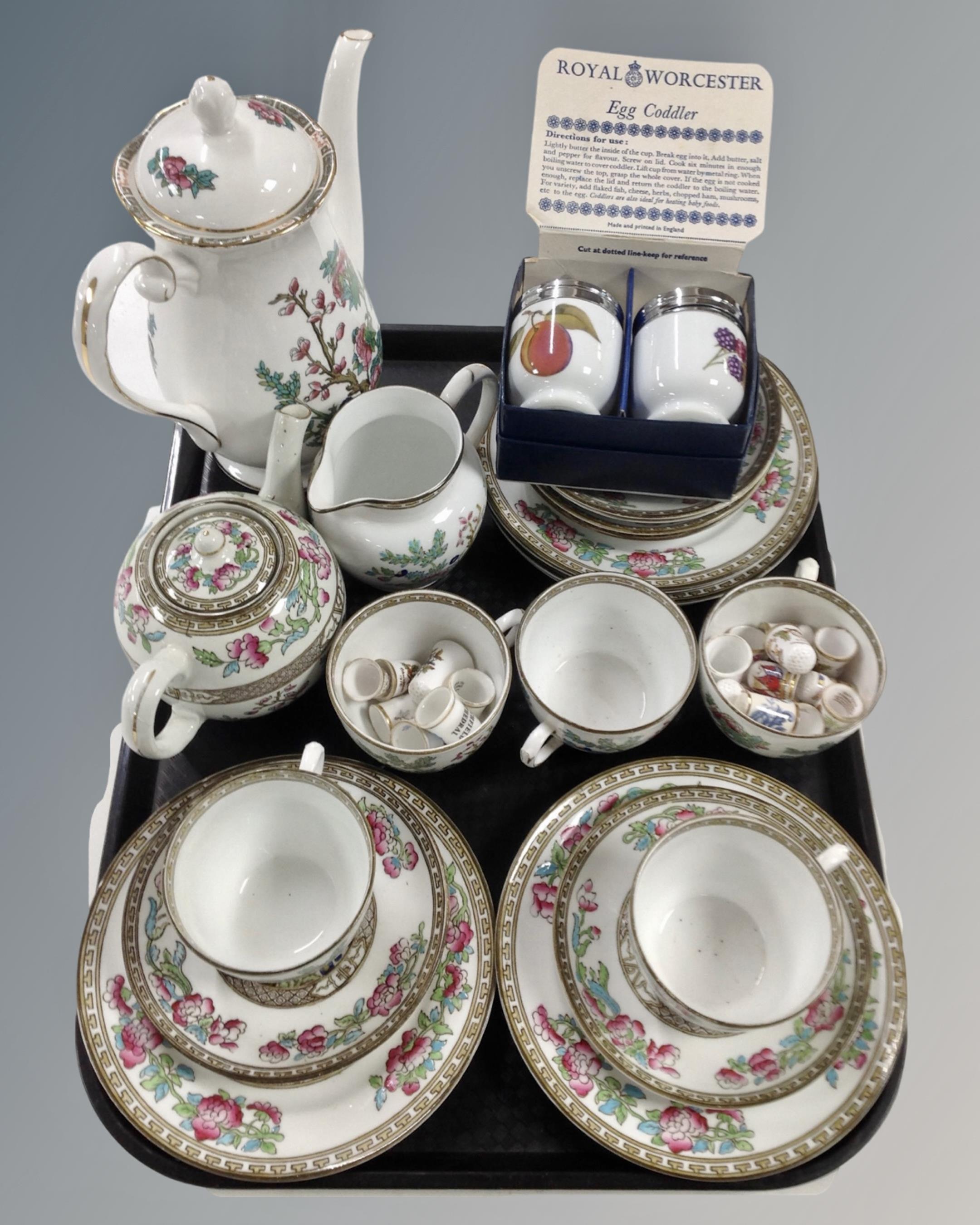 A tray containing a pair of boxed Royal Worcester egg coddlers,