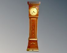 A Continental painted longcase clock with circular dial, pendulum and weights.