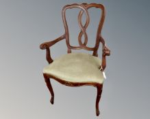 A stained beech armchair on cabriole legs.
