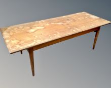 A mid-20th century teak coffee table with adjustable height.