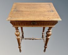 A late 19th century oak occasional table fitted with a drawer, on turned legs.