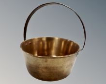 A brass cast iron handled jam pan.