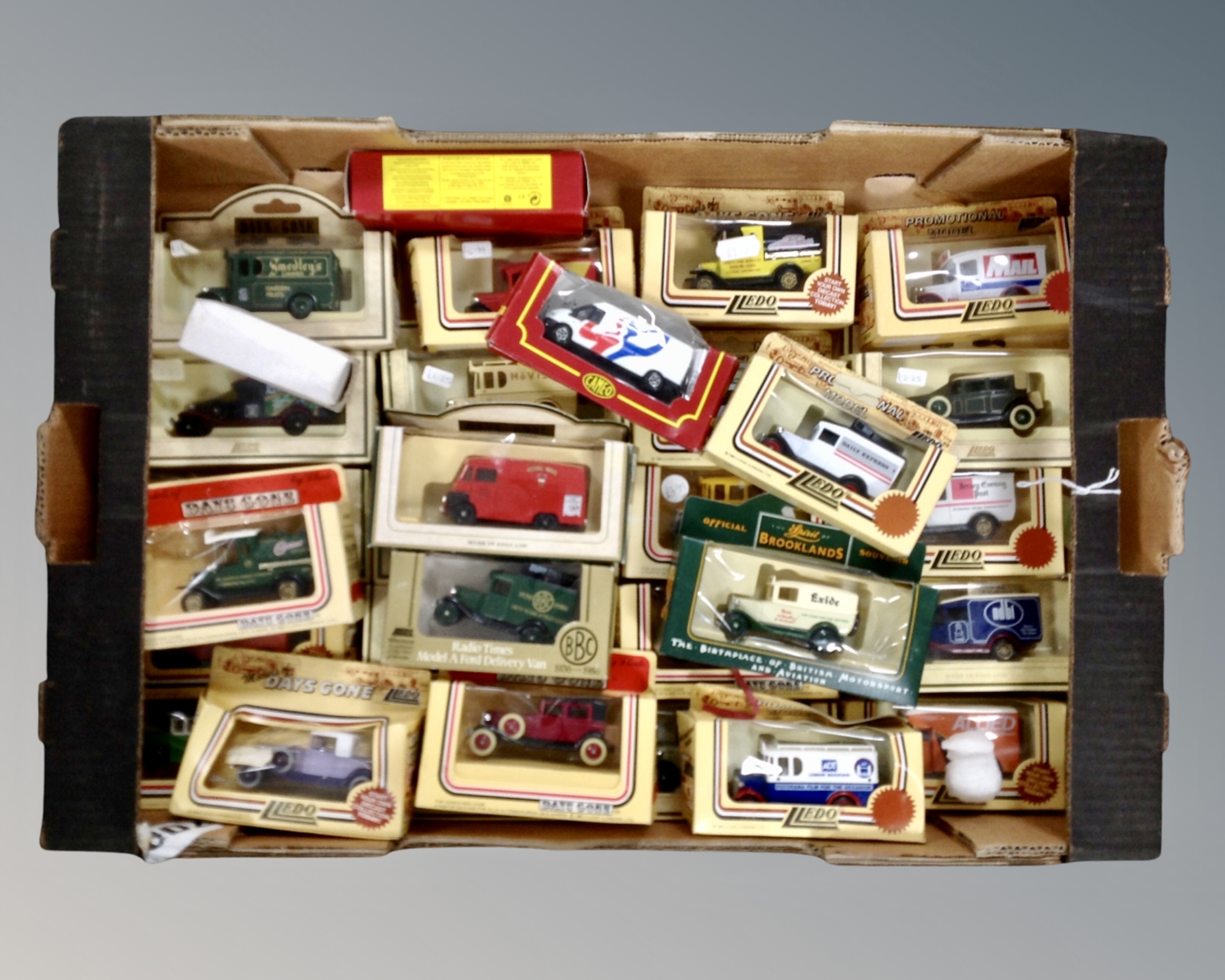 A box containing Lledo and Days Gone boxed die cast vehicles.
