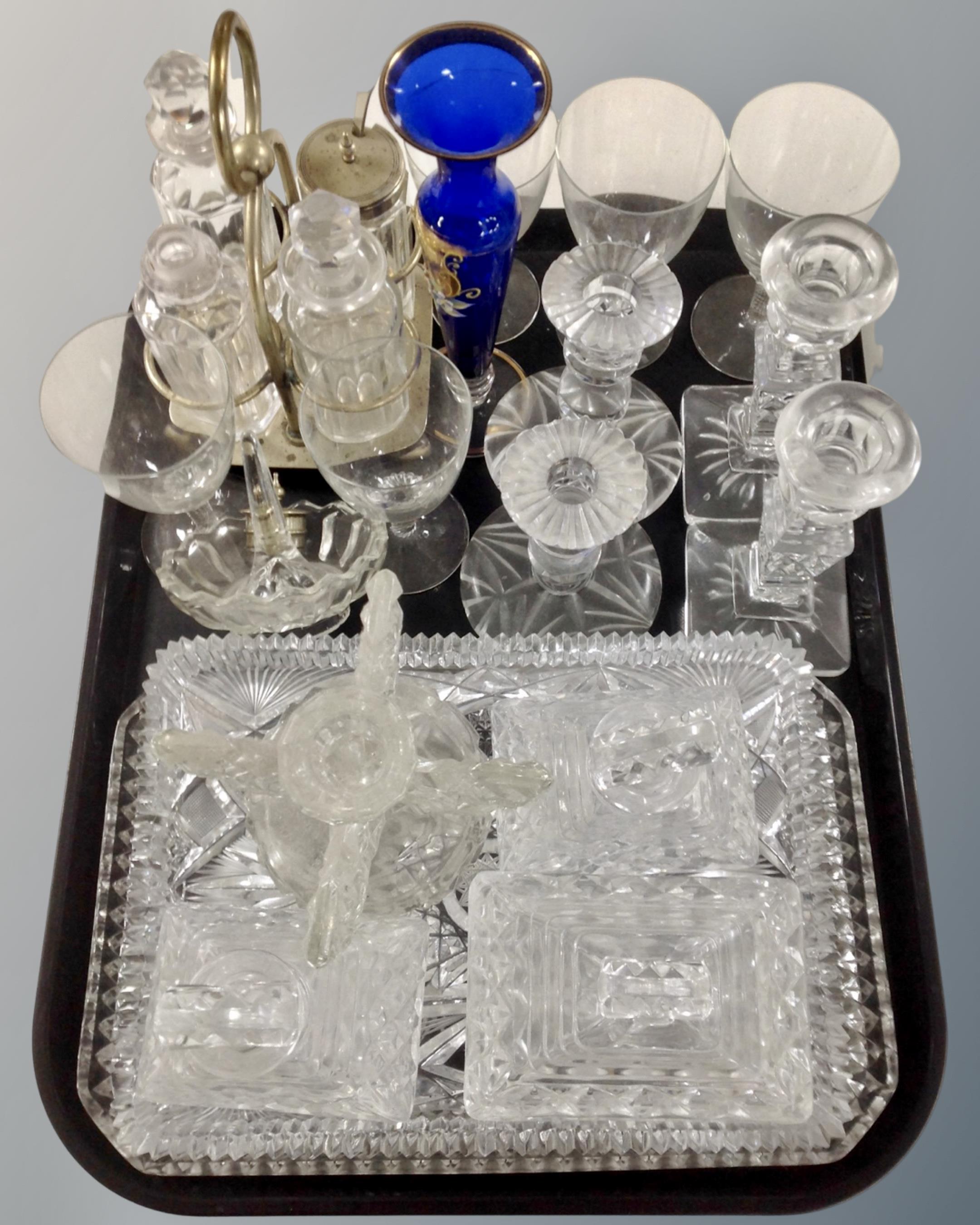 A tray containing a pressed glass dressing table set, pairs of candlesticks,